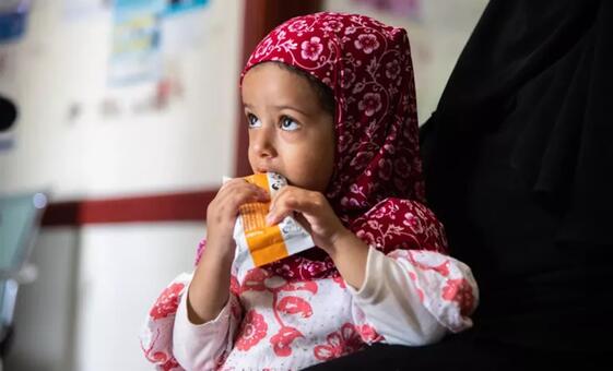 A young girl eating therapeutic food at a health centre in Yemen. The World Health Organization warned on Tuesday that it has run out of lifesaving supplies at its warehouse in Aden. 